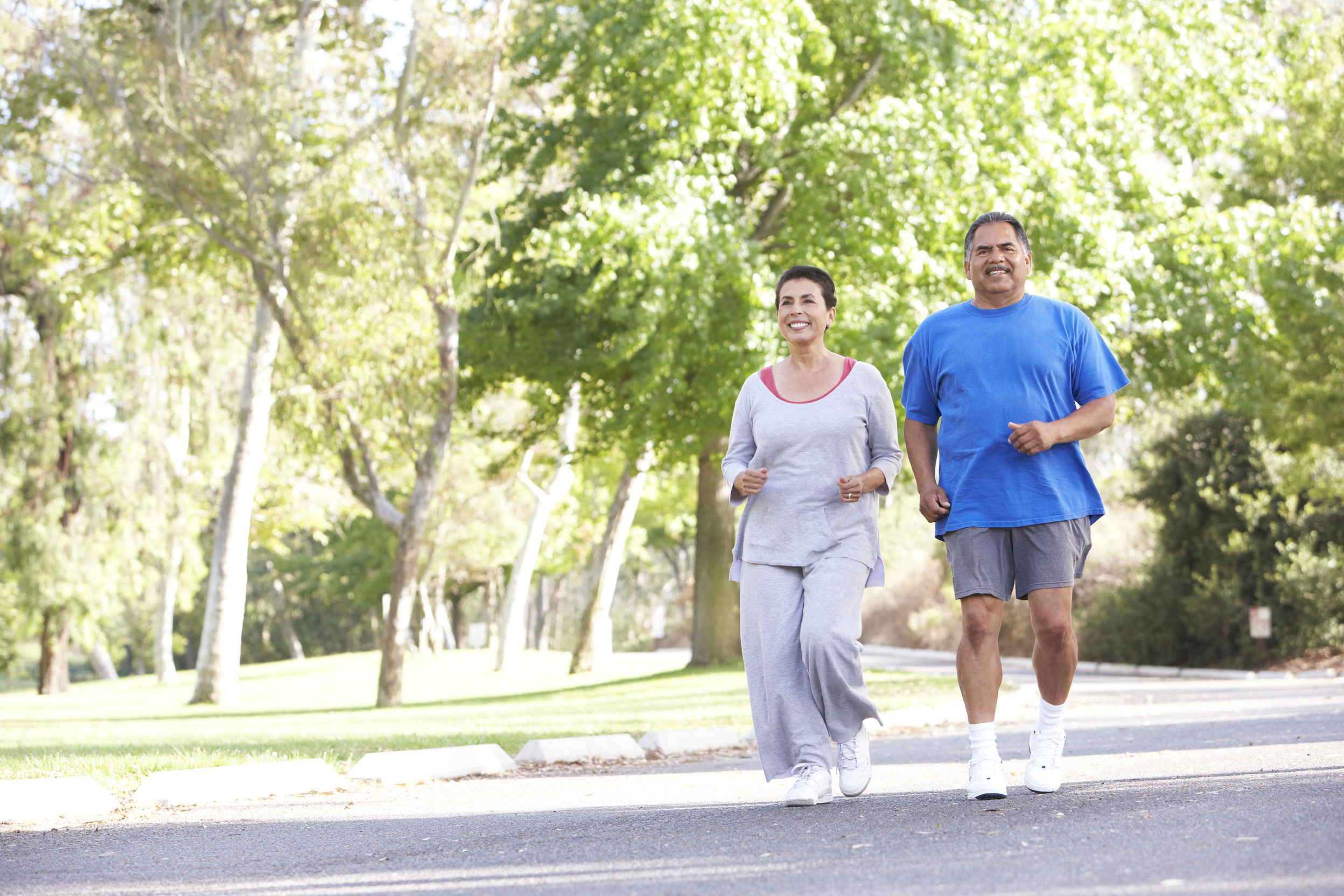 Senior Couple Jogging In Park
